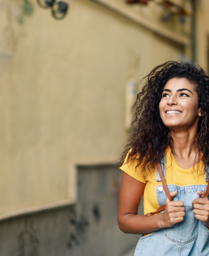 A man wearing a hat and sunglasses smiles as he walks down a city street. Text on the image reads "NORTH AMERICA CONNECT" and "Stay connected with family & friends in North America for only $10/mo." with buttons that say "Add to My Account" and "See Plan Details".